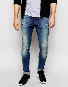 Супероблегающие джинсы с потертостями ASOS - Умеренный синий