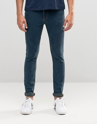 Выбеленные супероблегающие джинсы темного цвета ASOS - Темный синий