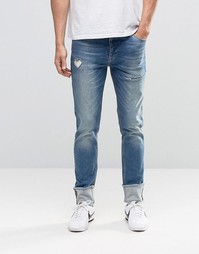 Зауженные джинсы с отворотами и прорехами ASOS - Умеренный синий
