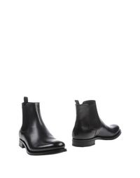 Полусапоги и высокие ботинки Prada