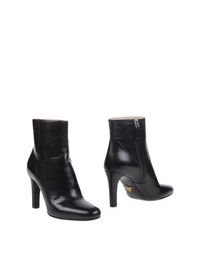 Полусапоги и высокие ботинки Prada
