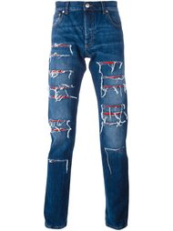 джинсы с рваными деталями Alexander McQueen