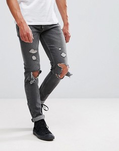 Черные выбеленные джинсы скинни с рваной отделкой ASOS - Черный