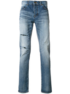 джинсы с потертой отделкой Saint Laurent
