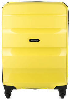 Желтый чемодан на колесах American Tourister