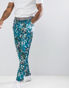 Сине-зеленые сатиновые брюки супероблегающего кроя с цветочным принтом ASOS DESIGN - Зеленый