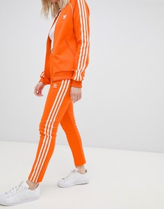 Оранжевые брюки-сигареты с тремя полосками Adidas Originals - Оранжевый