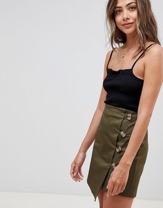 Мини-юбка с асимметричным запахом и пуговицами ASOS DESIGN - Зеленый