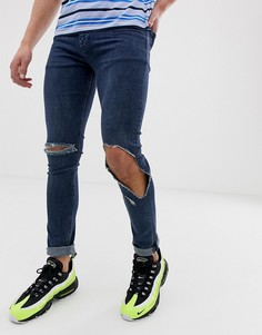 Темно-синие выбеленные джинсы скинни с рваной отделкой ASOS DESIGN - Синий