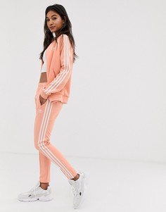 Розовые узкие брюки с тремя полосками adidas Originals adicolor - Розовый