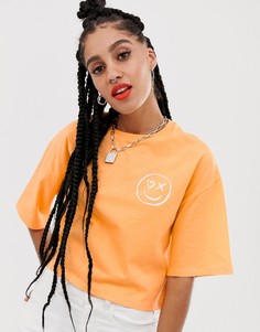 Неоновая выбеленная укороченная футболка со смайлом ASOS DESIGN - Оранжевый