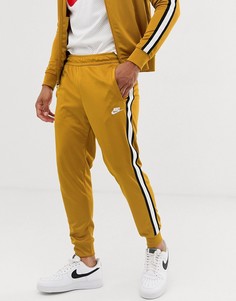 Золотистые спортивные брюки Nike Tribute - Золотой