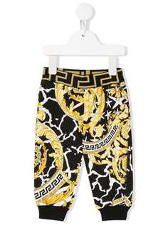 Young Versace baroque print trousers