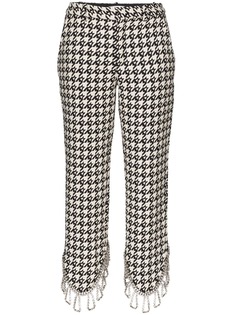 AREA asymmetric embellished houndstooth trousers