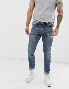 Темно-синие зауженные джинсы со вставками и рваной отделкой ASOS DESIGN-Синий