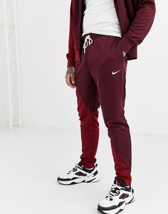 Бордово-красные джоггеры с манжетами и логотипом-галочкой Nike-Красный