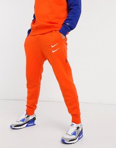 Оранжевые джоггеры с кромкой манжетом и логотипом-галочкой Nike-Оранжевый