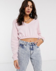 Розовый короткий свитшот с эластичным нижним краем Bershka