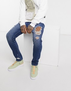 Темно-синие рваные джинсы с заниженным шаговым швом ASOS DESIGN-Синий