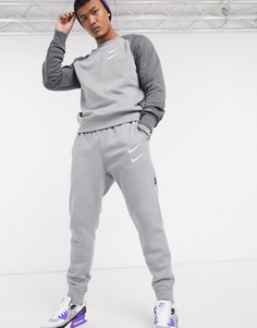 Серые джоггеры с манжетами и логотипом-галочкой Nike-Серый