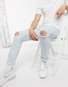 Светлые эластичные джинсы с рваными коленями ASOS DESIGN-Синий