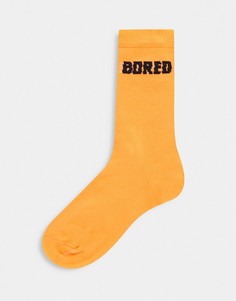 Оранжевые носки с надписью "Bored" ASOS DESIGN-Оранжевый