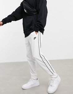 Белые джоггеры с манжетами и фирменными полосами Nike Repeat Pack-Белый
