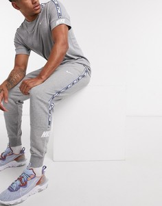 Серые джоггеры с манжетами и логотипом Nike Repeat Pack-Серый