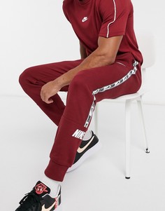 Бордовые джоггеры с манжетами и фирменной лентой Nike Repeat Pack-Красный