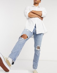 Светлые узкие джинсы с рваными коленями ASOS DESIGN-Синий