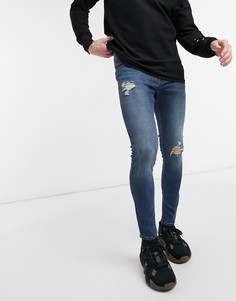 Темно-синие выбеленные эластичные рваные джинсы-скинни ASOS DESIGN-Синий