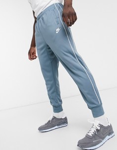 Голубые джоггеры с манжетами и отделкой фирменной лентой Nike Repeat Pack-Синий