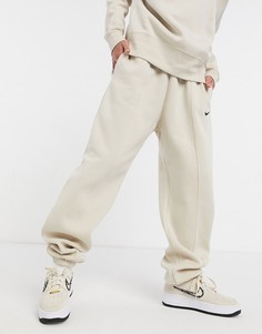 Бежевые джоггеры в стиле oversized с маленьким логотипом-галочкой Nike-Кремовый