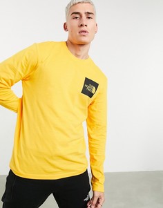 Желтый лонгслив The North Face