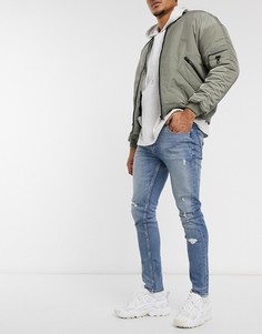 Светло-синие выбеленные рваные зауженные джинсы ASOS DESIGN-Голубой