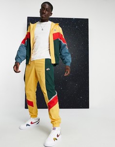 Джоггеры с манжетами горчичного цвета из тканого материала Nike Heritage Essentials Windrunner-Желтый