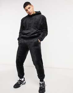 Черные спортивные штаны с пушистой фактурой и логотипом Puma Rebel-Черный
