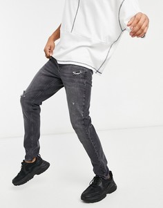 Зауженные черные выбеленные джинсы slim с эффектом потертости ASOS DESIGN-Черный цвет