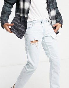 Светло-голубые выбеленные узкие джинсы стретч с рваной отделкой на бедре ASOS DESIGN-Голубой