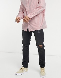 Узкие эластичные джинсы выбеленного черного цвета со рваной отделкой на коленях и потертостями ASOS DESIGN-Черный цвет