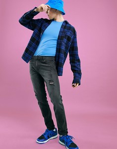 Зауженные джинсы черного выбеленного цвета с рваной отделкой ASOS DESIGN-Черный цвет