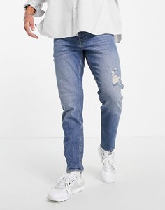 Темно-выбеленные в винтажном стиле, суженные книзу эластичные джинсы с эффектом состаренности ASOS DESIGN-Голубой