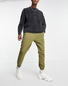 Суженные книзу брюки-чиносы цвета хаки с эластичным поясом ASOS DESIGN-Зеленый цвет