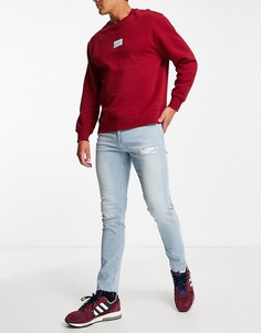 Светлые облегающие джинсы с рваной отделкой ASOS DESIGN-Голубой