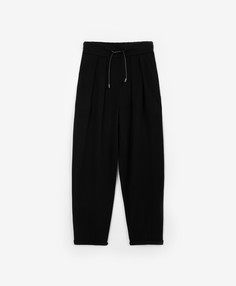 Брюки трикотажные зауженные с манжетами чёрные для девочки Gulliver (140)